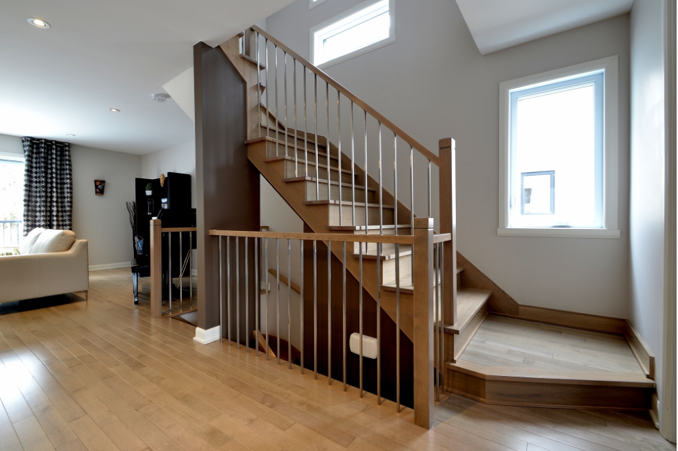 wooden staircase banister with metal balusters